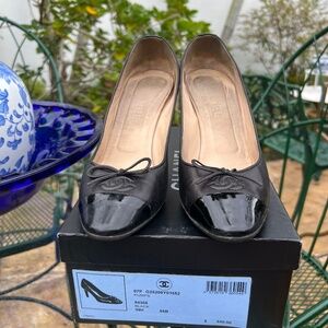 Chanel black leather and black pattern pumps